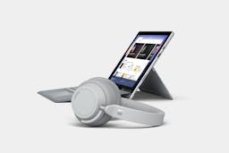 A Surface Pro shows a podcast app concept, with a pair of Surface Headphones in front of it.