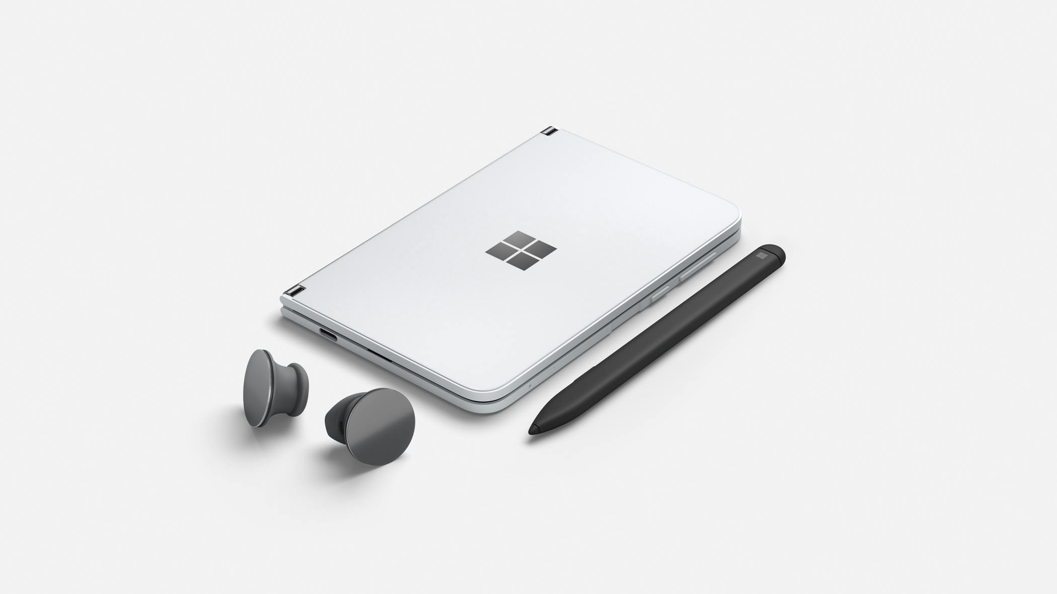 Surface Duo is the result of years of Surface design and research. Pictured with Surface Slim Pen and Surface Earbuds.